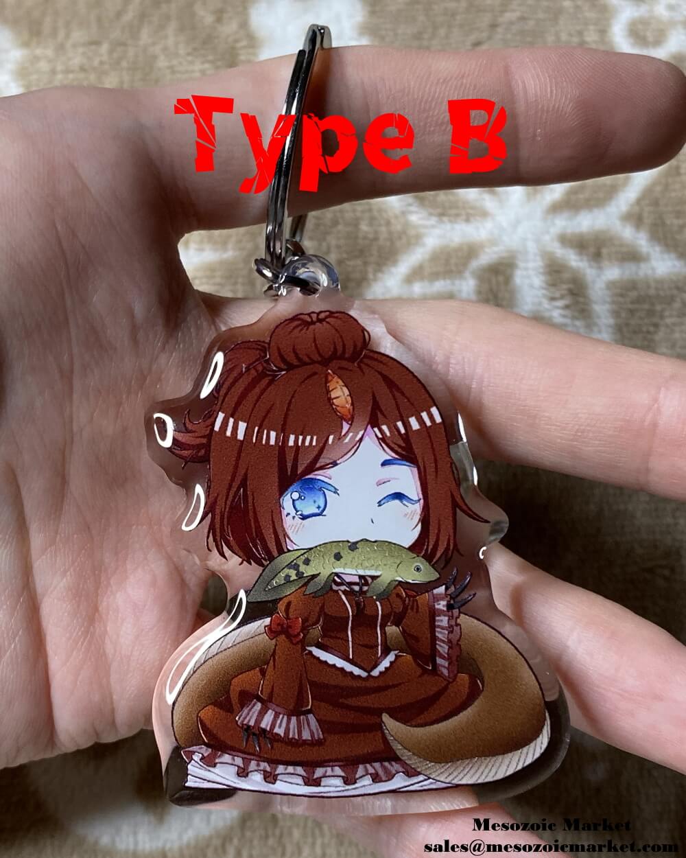 Type B variant of an acrylic keychain of our Spinosaurus anime girl mascot eating a lungfish.